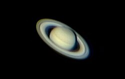 Saturn image using negative projection (Barlow lens) with a webcam attached to a 250mm Newtonian telescope. It is a composite image made from 10% of the best exposures out of 1200 images.