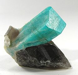 Deep robins-egg blue color amazonite crystal on smoky quartz and albite, from Teller County, Colorado. Size: 3.4 cm × 3.3 cm × 2.5 cm (1.3 in × 1.3 in × 1.0 in).