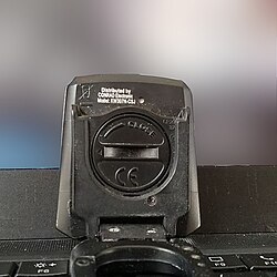 Coin slot-style screw head on a battery holder, capable of being opened using the CR2032 battery.
