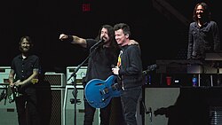 Rick Astley on stage with the Foo Fighters