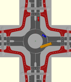 A single lane roundabout with a bidirectional circulatory cycle track and set back cycle crossings. Cyclists must give way to vehicles leaving and joining the roundabout.